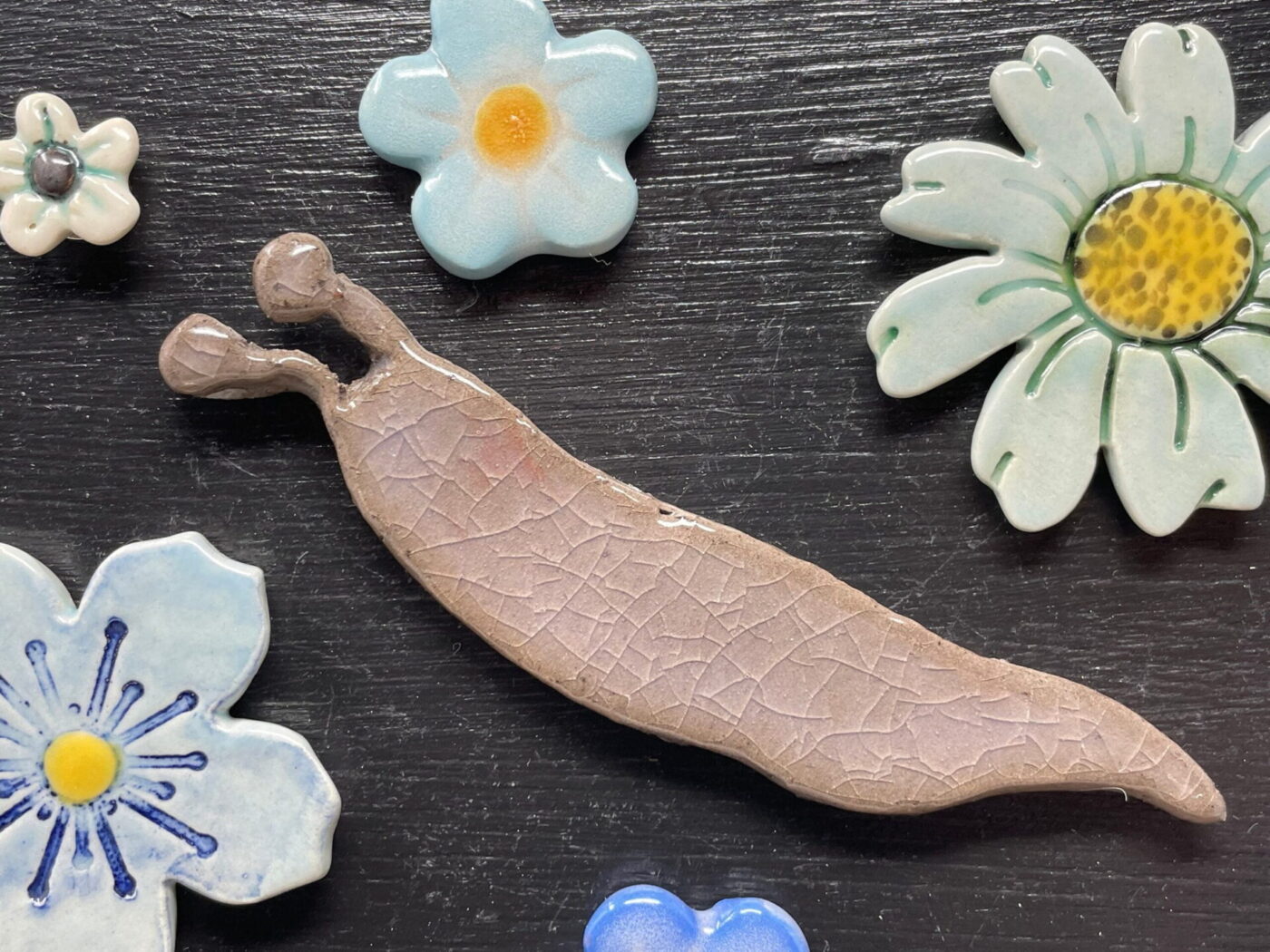 Ceramic Slug & Blue Flowers Magnet Set — close-up
