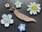 Ceramic Slug & Blue Flowers Magnet Set — in use