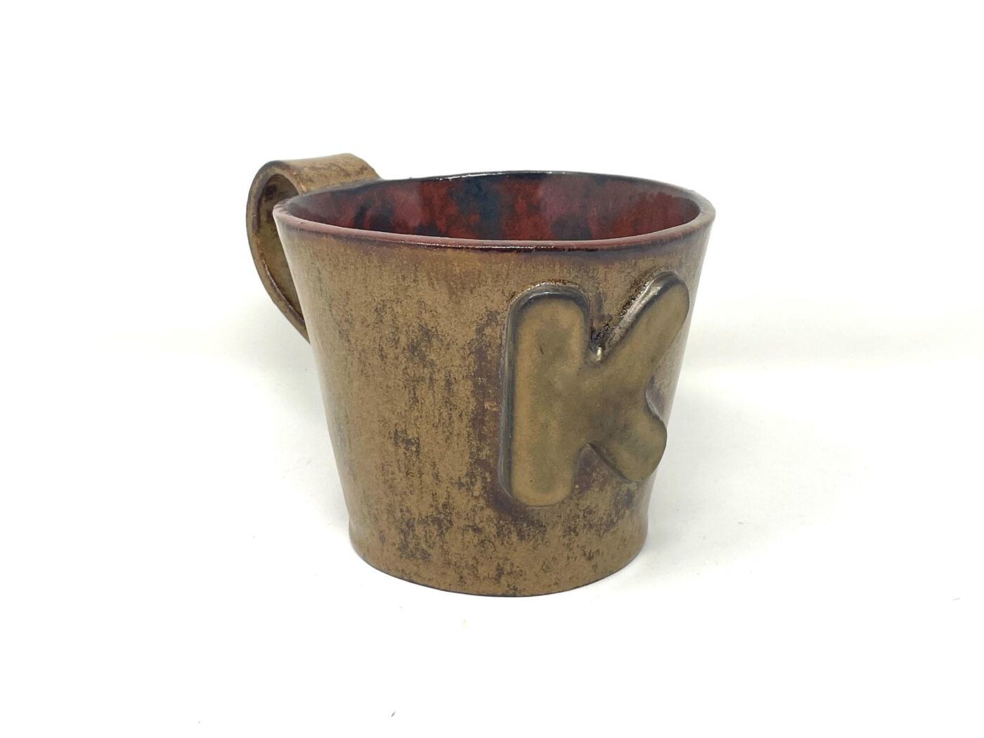 XL Ceramic Mug — "K" Initial, Light Brown & Red — in use