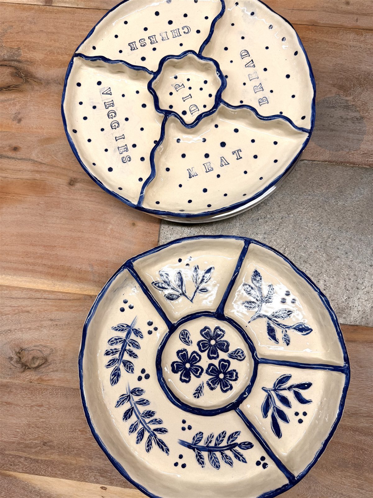 Overhead view of two cream-and-blue personalised ceramic snack trays